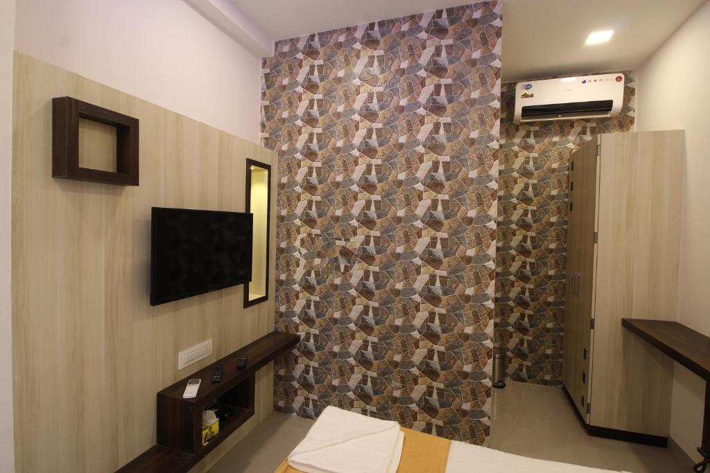 a room with a wall with a stone wall at Golden Residency in Mumbai