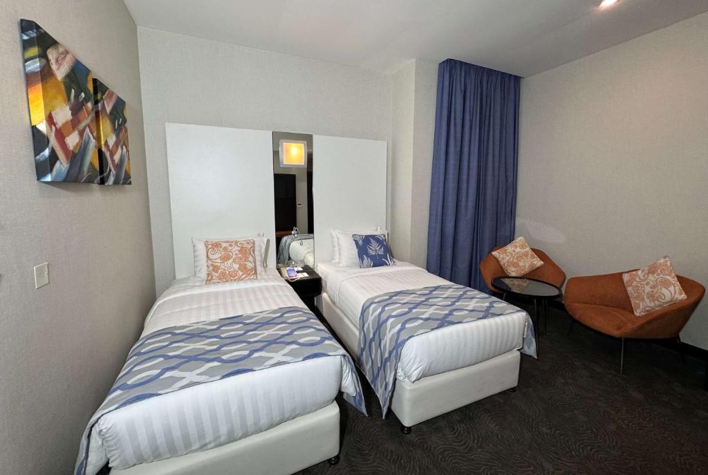 Voodi või voodid majutusasutuse Ramada Encore Doha by Wyndham toas