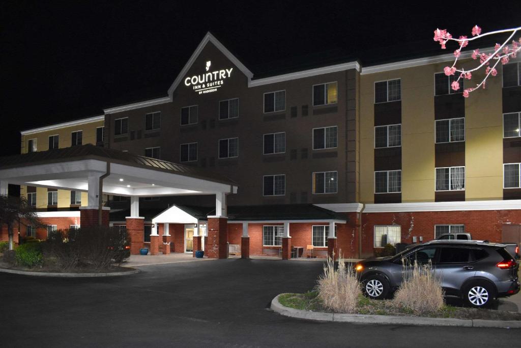 a car parked in front of a hotel at night at Country Inn & Suites by Radisson, Hagerstown, MD in Hagerstown