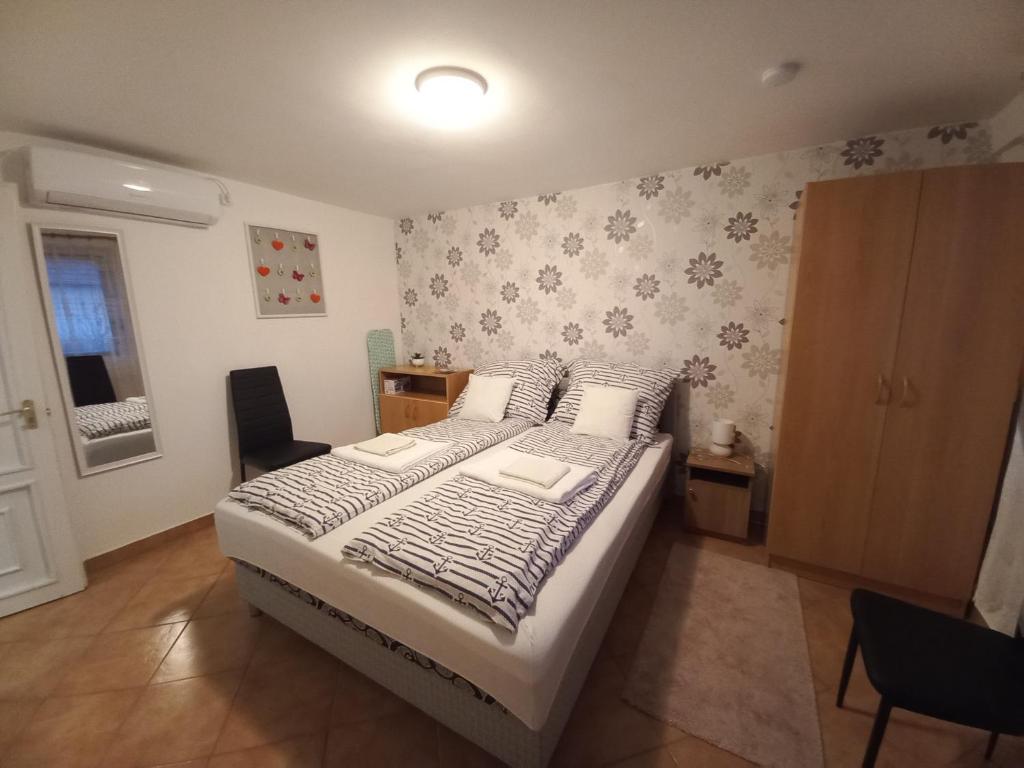 A bed or beds in a room at Sándor Apartman