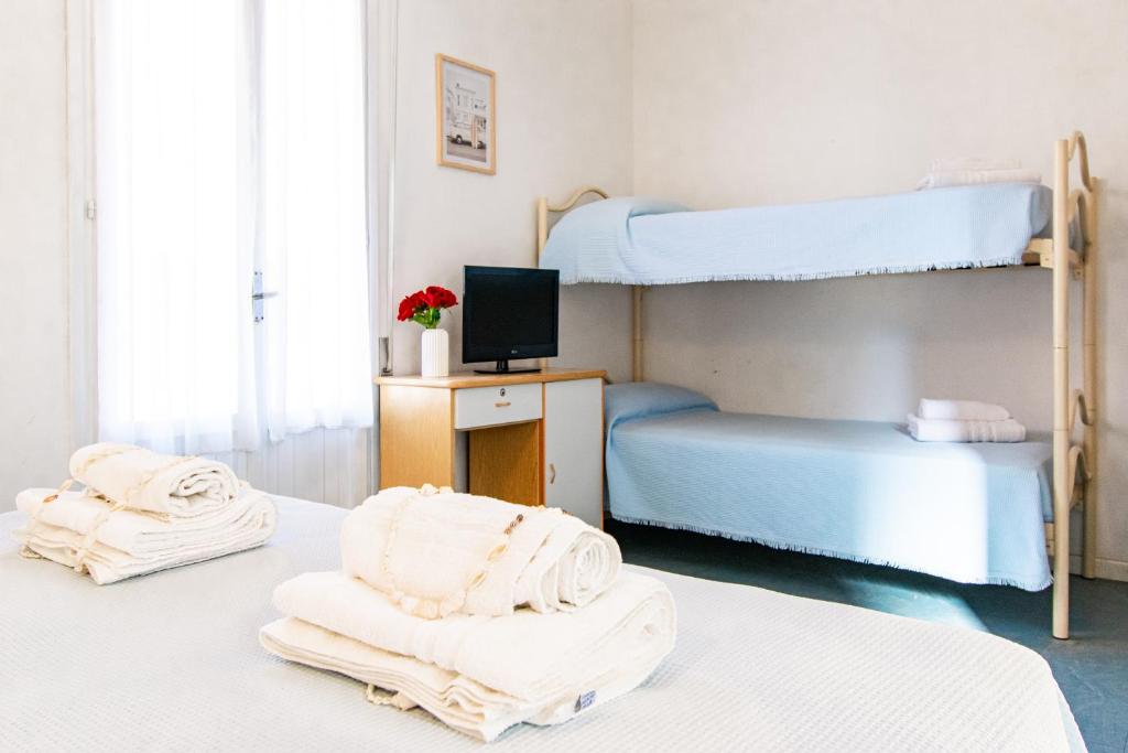 Postel nebo postele na pokoji v ubytování Hotel Lucciola