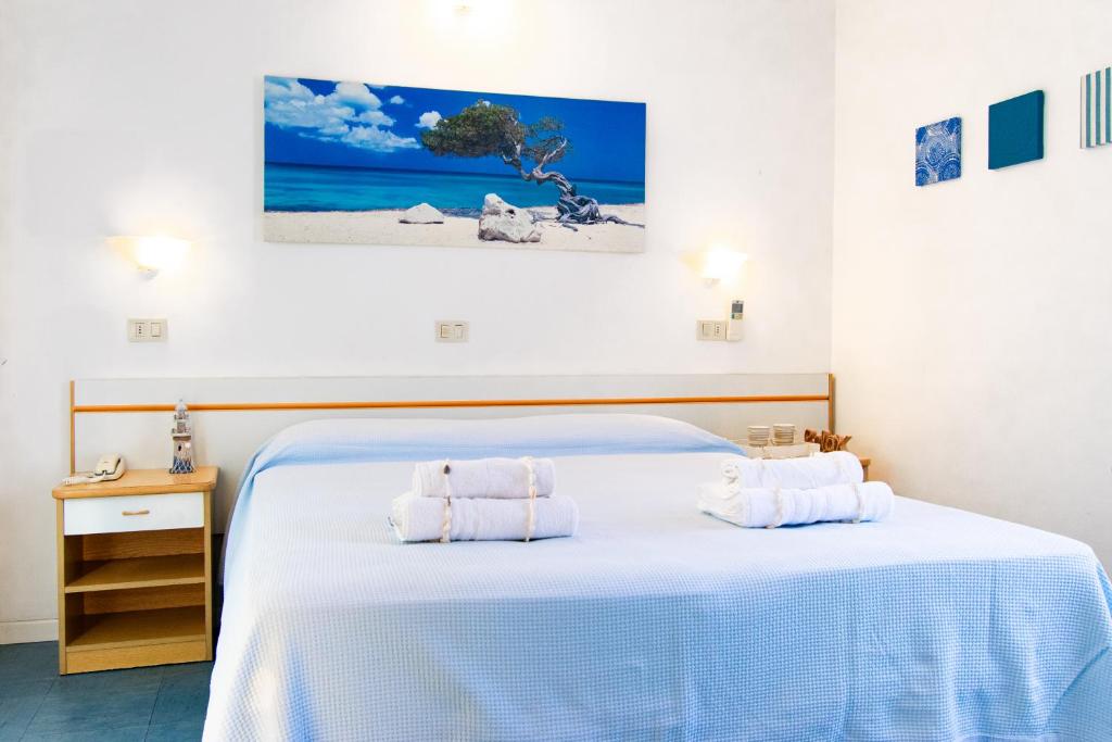 Postel nebo postele na pokoji v ubytování Hotel Lucciola