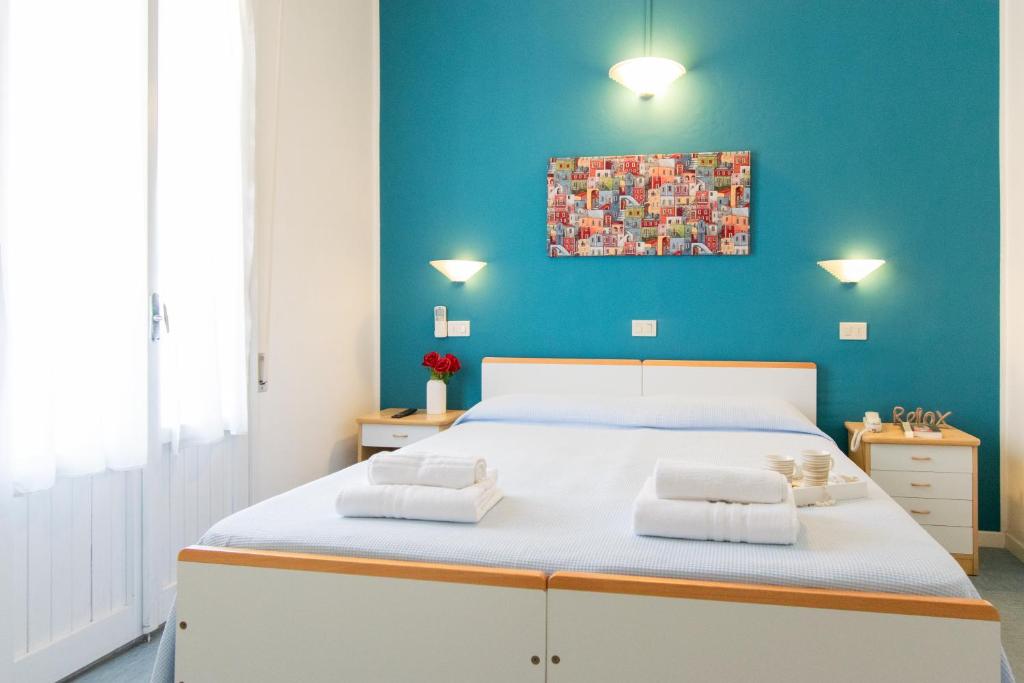 Postel nebo postele na pokoji v ubytování Hotel Lucciola