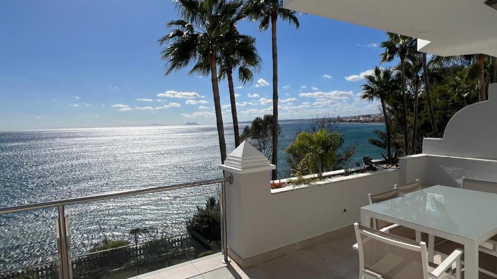 a view of the ocean from a house balcony at Estepona Beach Front Apartment with Stunning Sea Views in Estepona