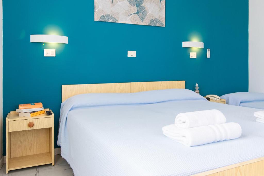 Postel nebo postele na pokoji v ubytování Hotel Lucciola