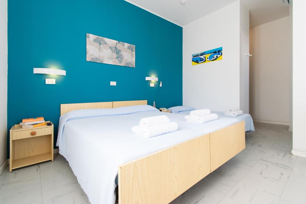Postel nebo postele na pokoji v ubytování Hotel Lucciola