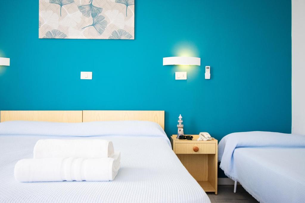 Postel nebo postele na pokoji v ubytování Hotel Lucciola