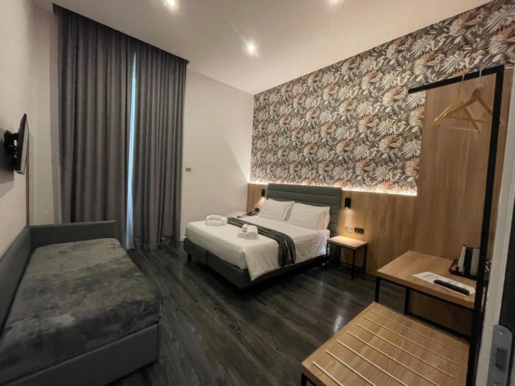 Postel nebo postele na pokoji v ubytování Hotel Delle Camelie