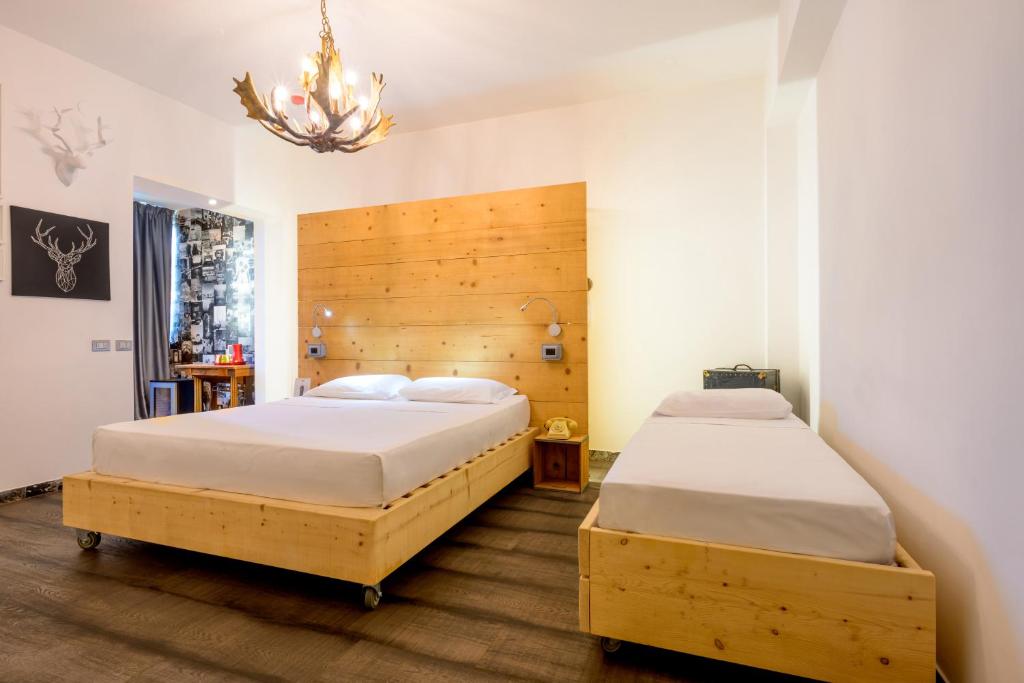 Postel nebo postele na pokoji v ubytování Hotel Perla - The storyhoteller