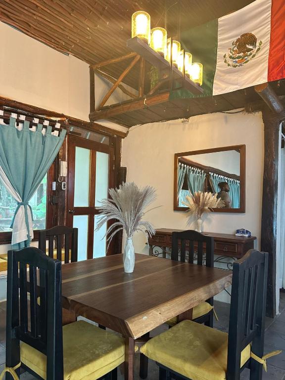 a dining room with a wooden table and chairs at Treehouse Loft in Prime Location in Playa del Carmen