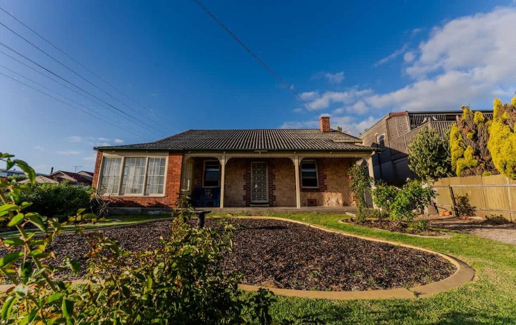 a house with a garden in front of it at Summers Cottage - Port Noarlunga in Port Noarlunga