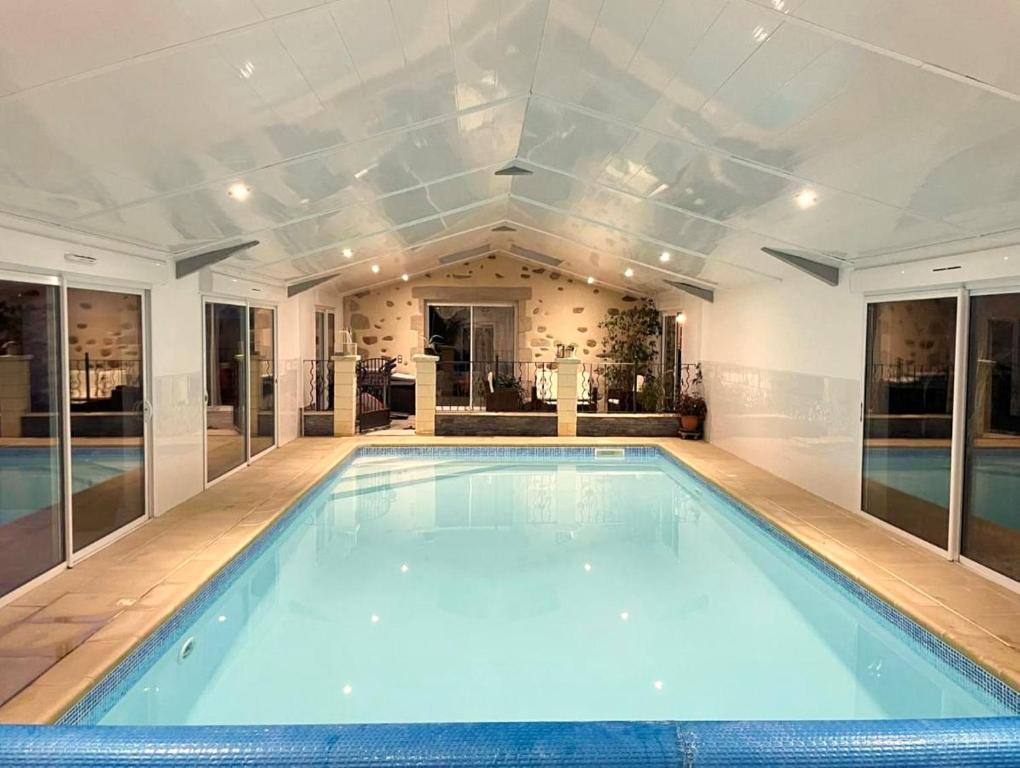 a large swimming pool in a large room at "La Petite Félixière" à 25 min du Puy du Foù, 10 min de Cholet, et 35 min de Nantes in Saint-André-de-la-Marche
