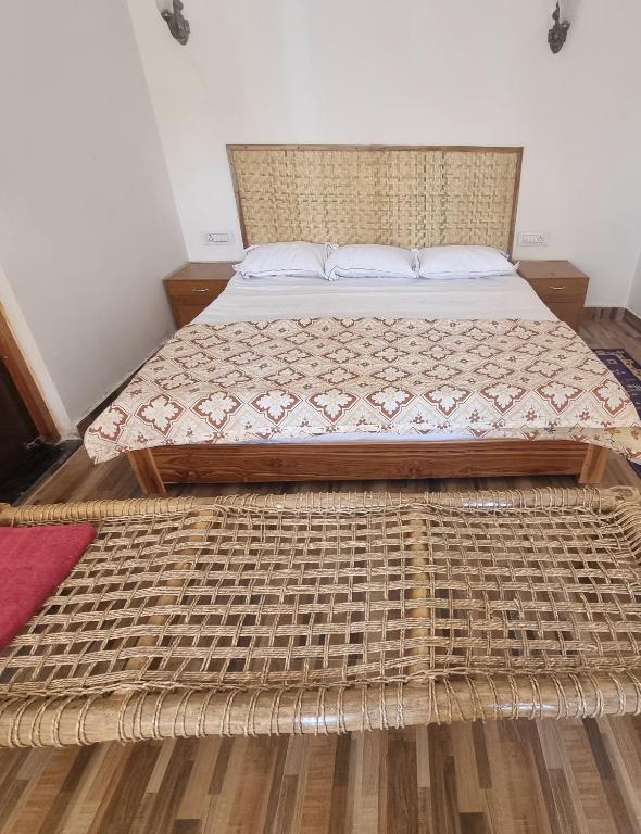 a large bed in a bedroom with a wooden floor at Neels camp Resorts in Panna