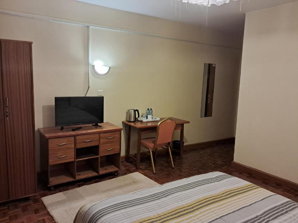 TV a/nebo společenská místnost v ubytování GRACEMONT Guesthouse
