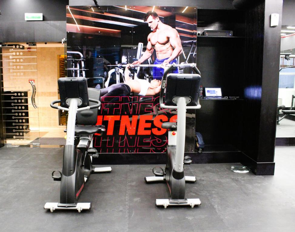 a man in a gym with two machines at City Tower Hotel in Fujairah