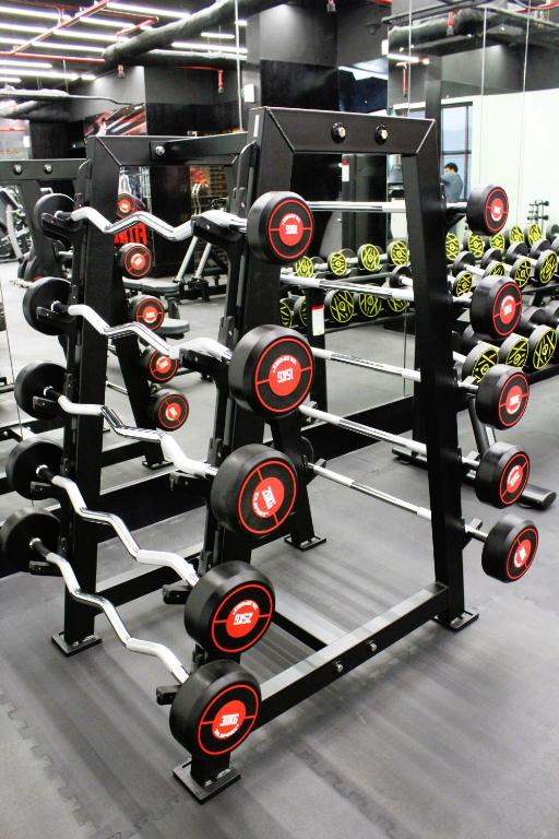 a gym filled with lots of dumbbells at City Tower Hotel in Fujairah
