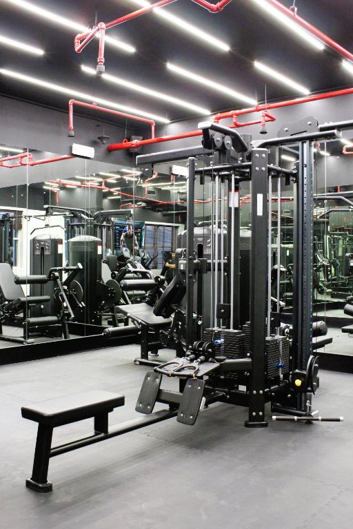 a gym with several treadmills and machines at City Tower Hotel in Fujairah