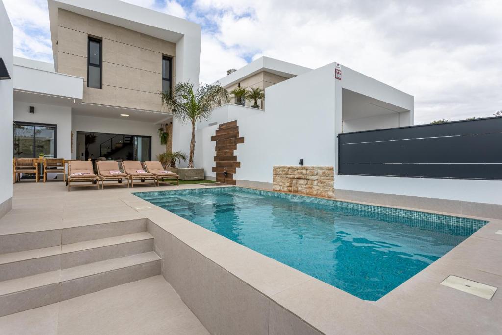 a swimming pool in the backyard of a house at Villa Nica in Dolores
