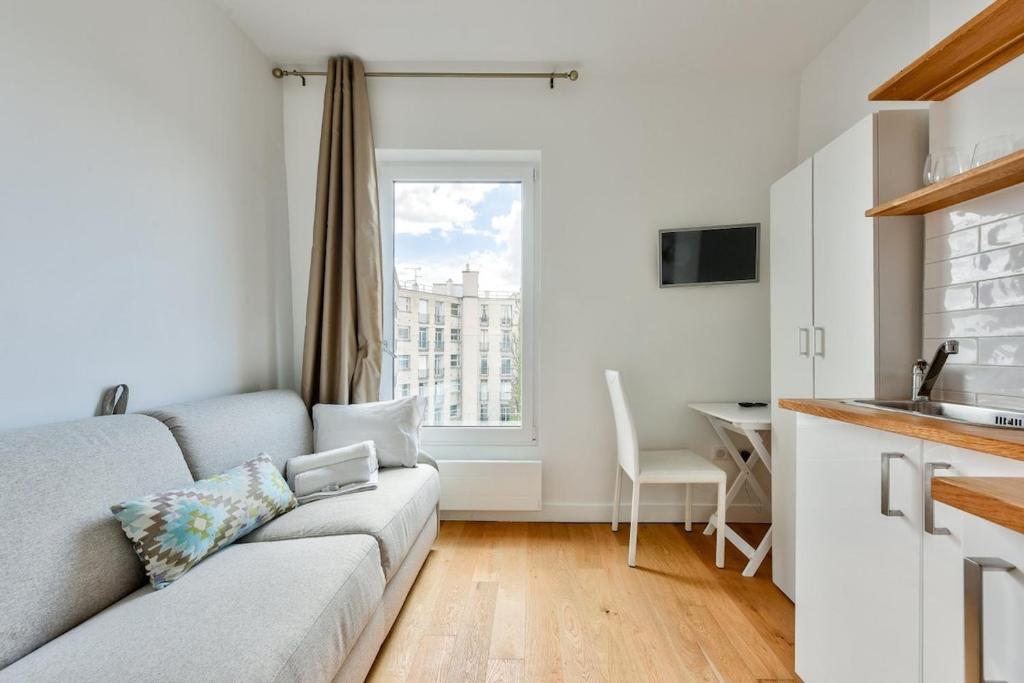 巴黎Studio with a panoramic view of the Eiffel Tower的带沙发的客厅和厨房