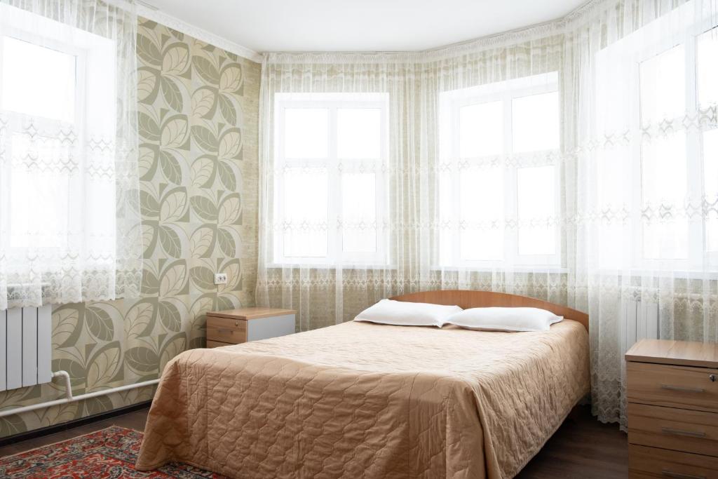 Ένα ή περισσότερα κρεβάτια σε δωμάτιο στο Гостевой Дом Маман