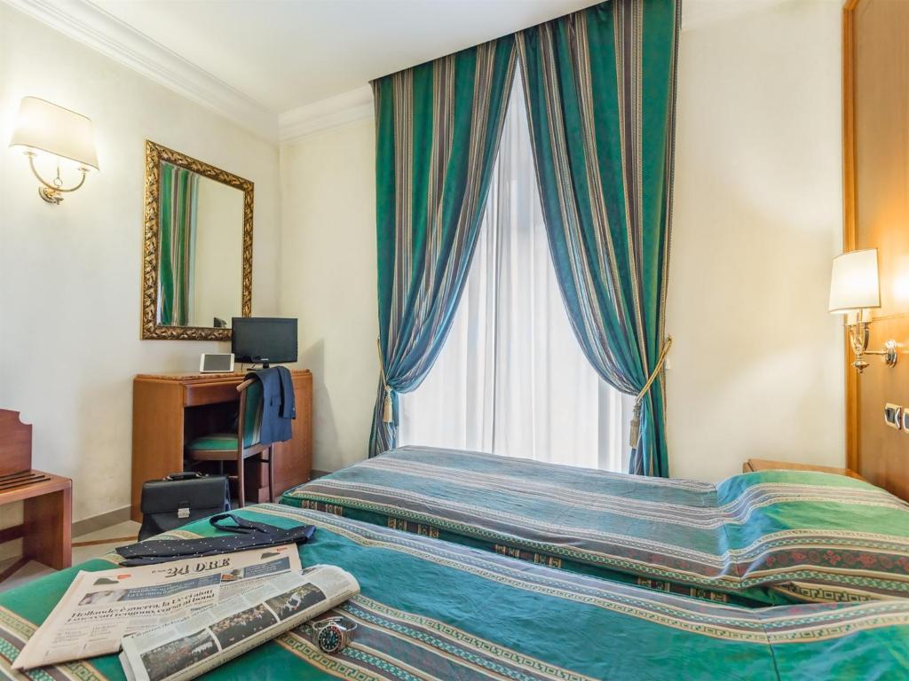 Postel nebo postele na pokoji v ubytování Raeli Hotel Regio