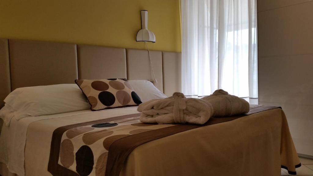 Postel nebo postele na pokoji v ubytování HOTEL TRIONFAL - Fronte Mare - Vicinissimi al Centro