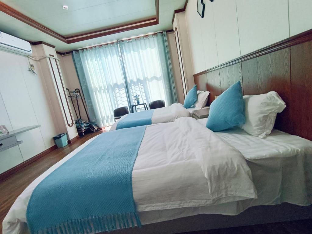 Postel nebo postele na pokoji v ubytování Meizhou Cloudy B&B