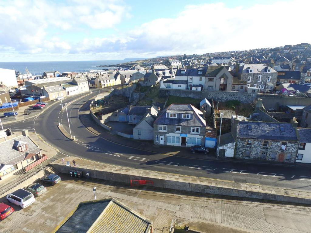 an aerial view of a town with a street at Coasters Holiday Flats in Macduff