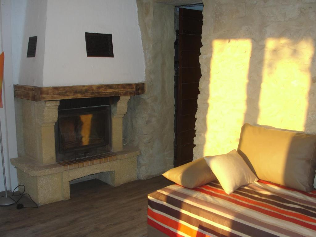 a living room with a couch and a fireplace at Le Mas De La Chérine in Quinson