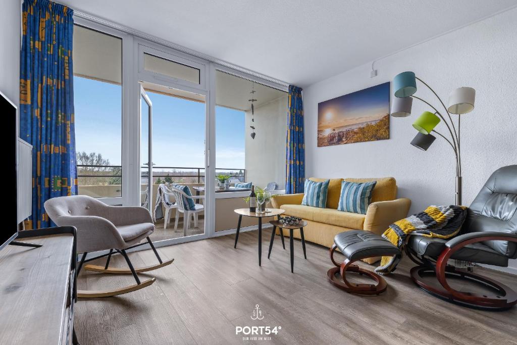a living room with a couch and a balcony at Ferienwohnung Sydvind 8408 Marina Wendtorf in Wendtorf