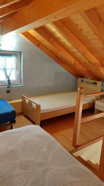 a bedroom with two bunk beds in a attic at Casa Angelino in Cannobio