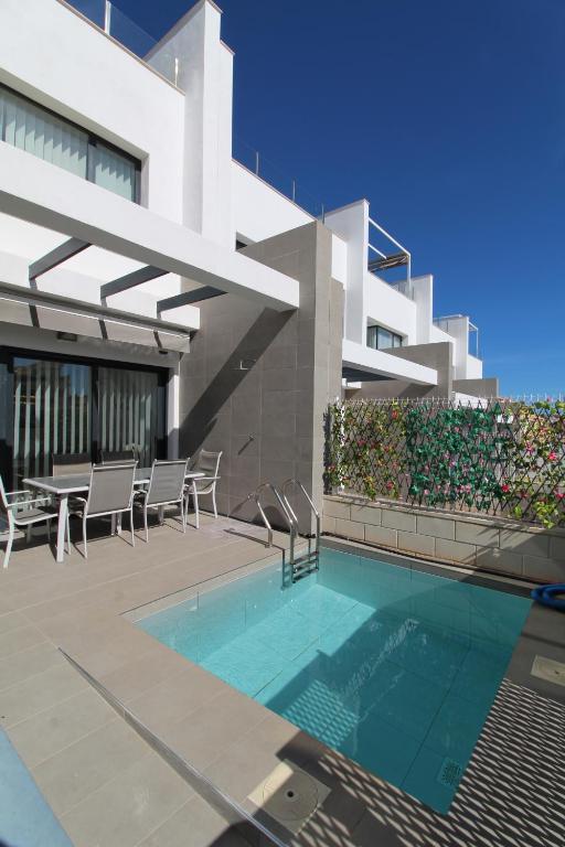 een zwembad voor een gebouw bij Fabulous Villa with private pool & large roof solarium in Villamartin