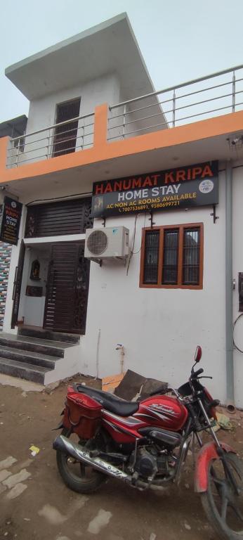 a red motorcycle parked in front of a building at Hanumat Kripa Home Stay in Ayodhya