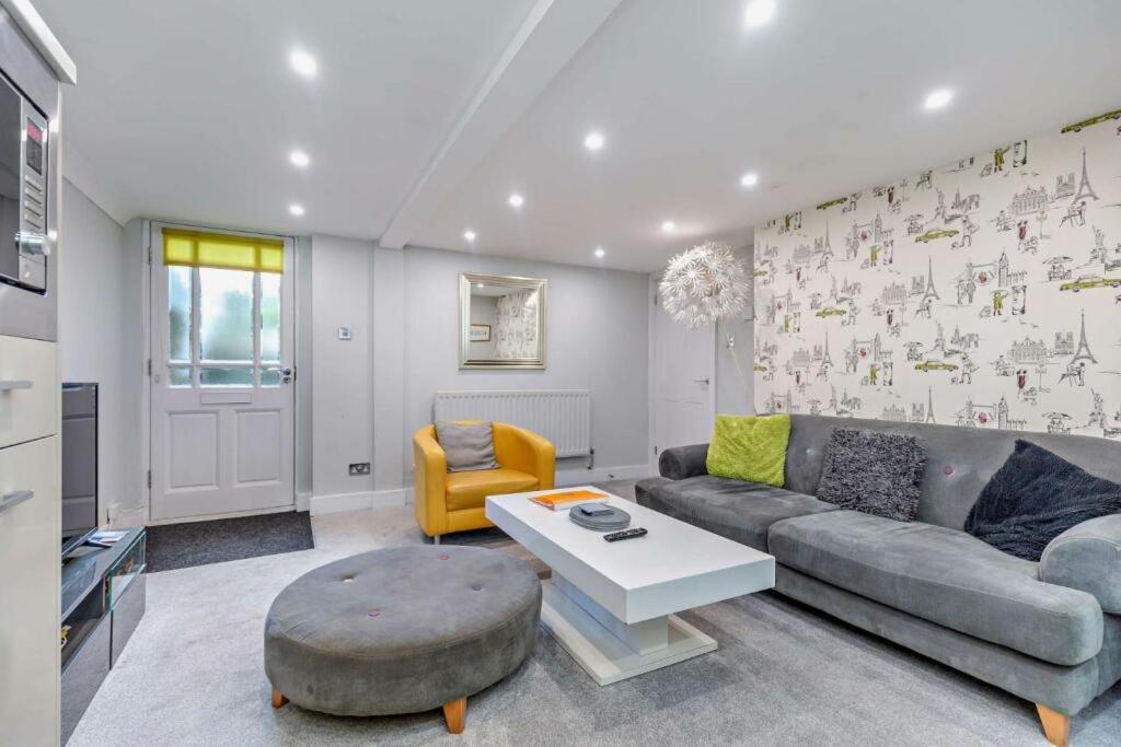 a living room with a couch and a table at Garden Mews - 2 double bedrooms - Harrogate Holiday Apartments in Harrogate