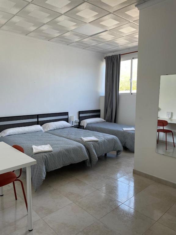 Postel nebo postele na pokoji v ubytování Hostal Kaizen