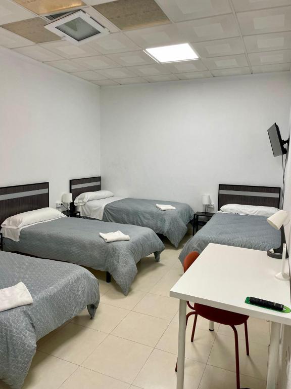 Postel nebo postele na pokoji v ubytování Hostal Kaizen