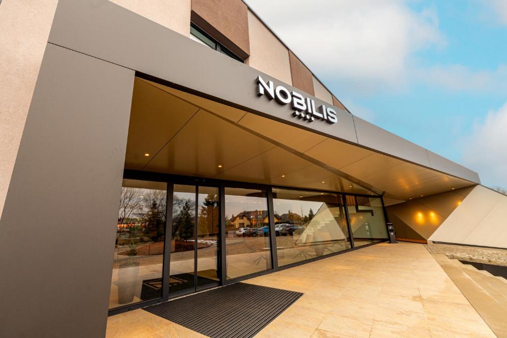 a building with a nordisk sign on the side of it at Hotel NOBILIS - Mladá Boleslav in Bradlec