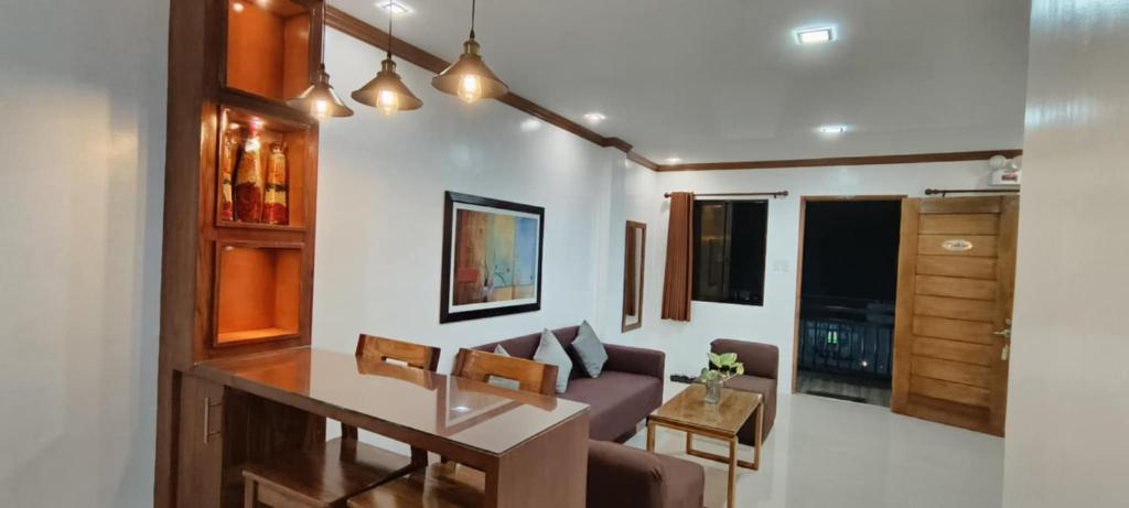 a living room with a couch and a table at Casa Victoria Pension House-Makra in Somosomo