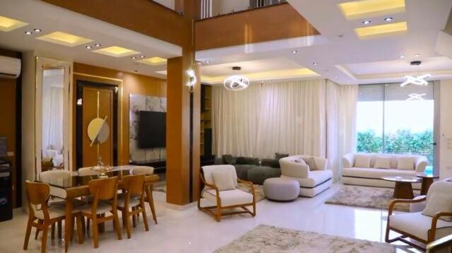 a living room with a table and chairs and a couch at Fully furnished Townhouse in Abū Rawwāsh