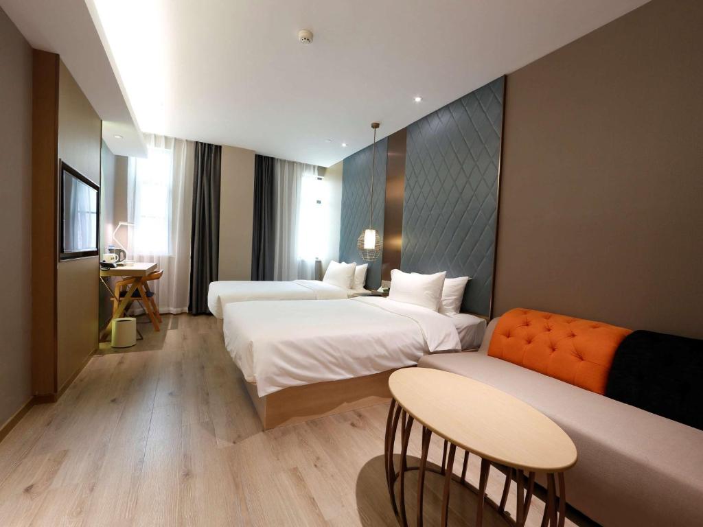 Postel nebo postele na pokoji v ubytování Ibis Styles XM Zhongshan Hotel