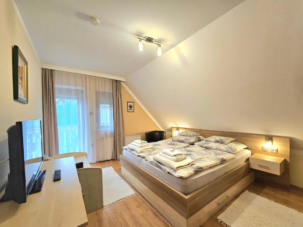 A bed or beds in a room at Apartman Siesta Bük - Bükfürdő