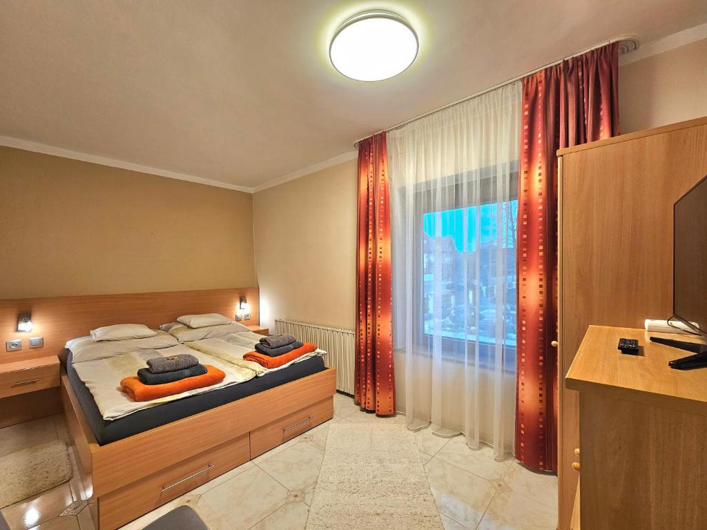 A bed or beds in a room at Apartman Siesta Bük - Bükfürdő