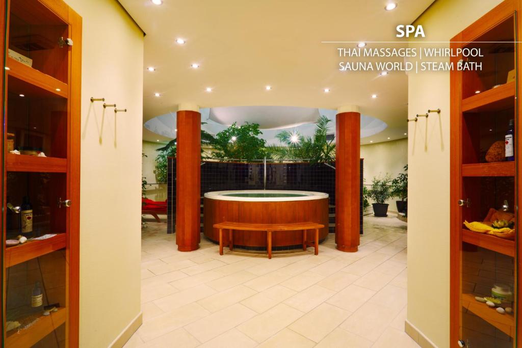 a spa with a round tub in the middle of a room at Don Giovanni Hotel Prague - Great Hotels of The World in Prague