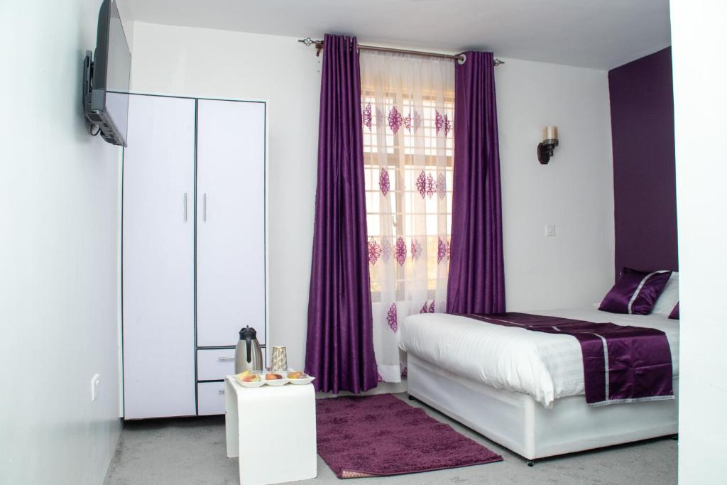 Postel nebo postele na pokoji v ubytování Nyams Boutique Hotel