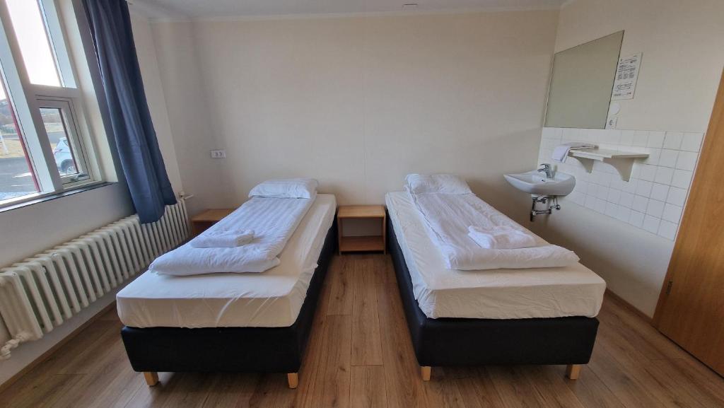 Rúm í herbergi á Hunavellir Guesthouse