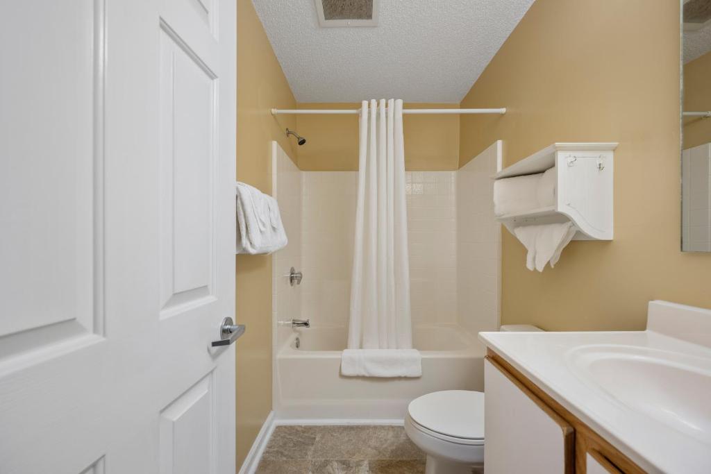 a bathroom with a sink and a toilet and a shower at Affordable Suites Myrtle Beach in Myrtle Beach