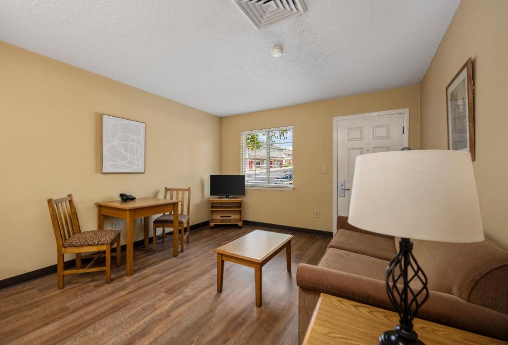 a living room with a couch and a table at Affordable Suites Myrtle Beach in Myrtle Beach