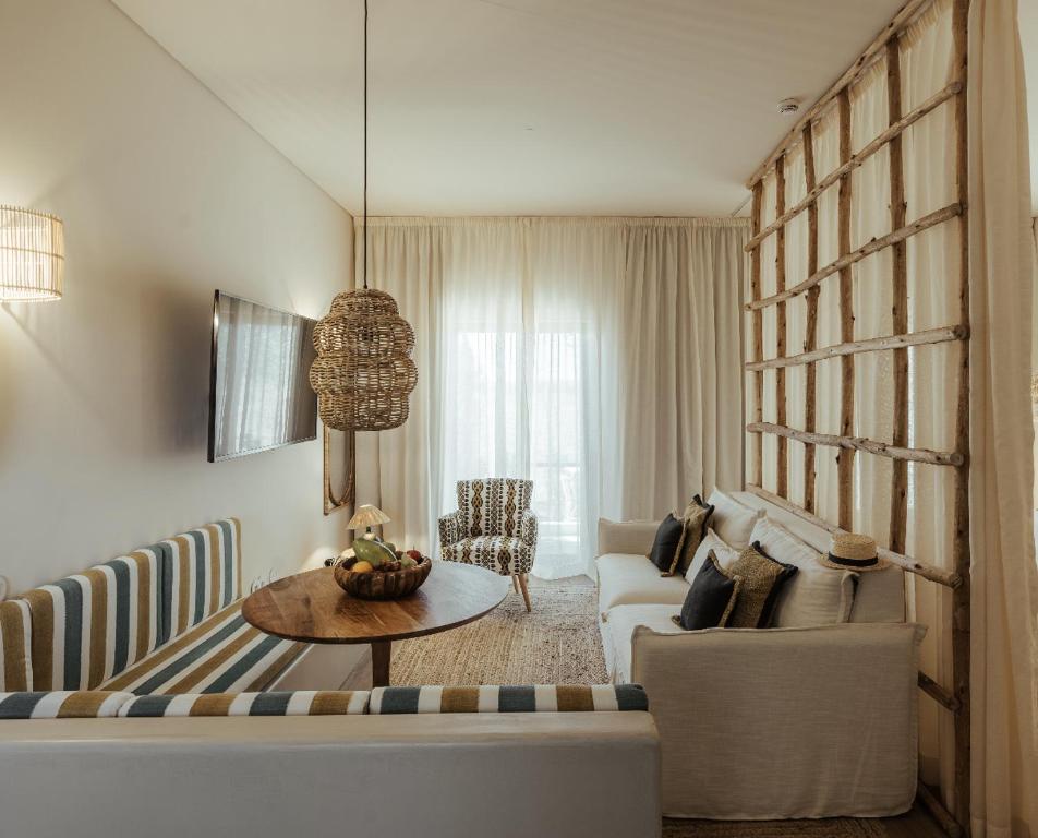 a living room with a couch and a table at AlmaLusa Comporta in Comporta