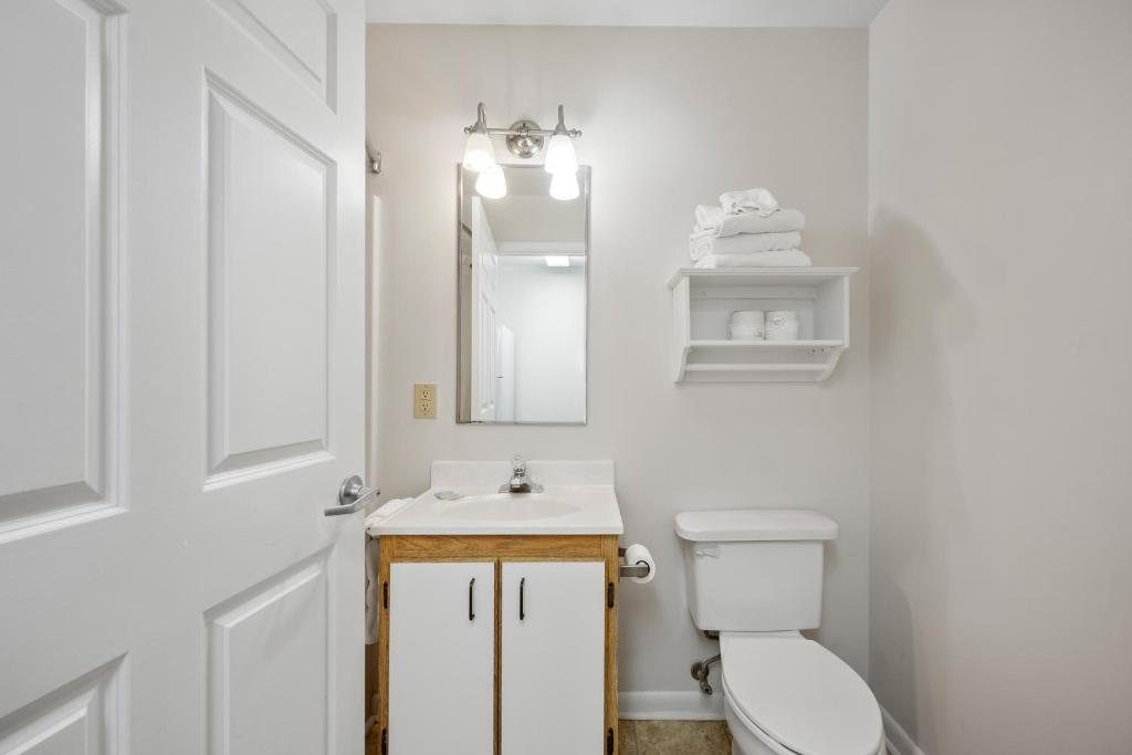 a bathroom with a toilet and a sink and a mirror at Affordable Suites Myrtle Beach in Myrtle Beach