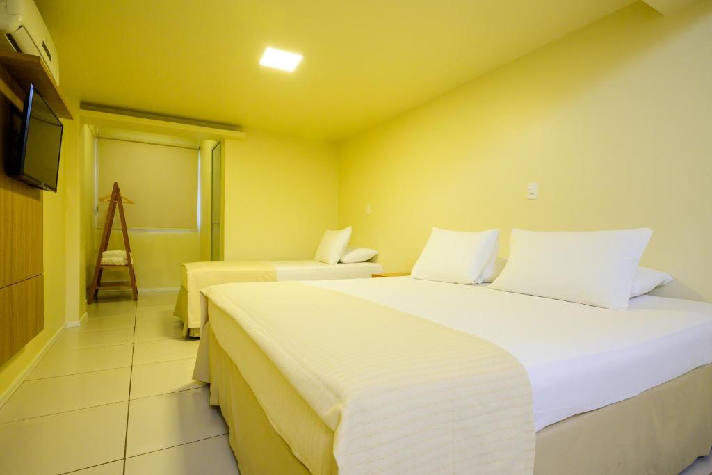 Postel nebo postele na pokoji v ubytování Nordeste Palace Hotel